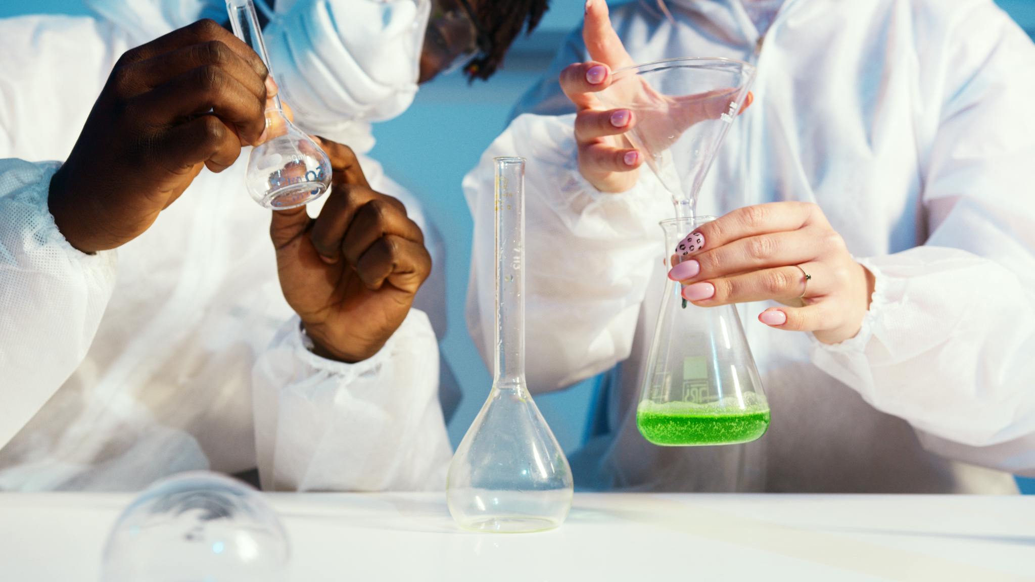 Two scientists working with chemicals in a lab, focusing on experimentation and analysis.
